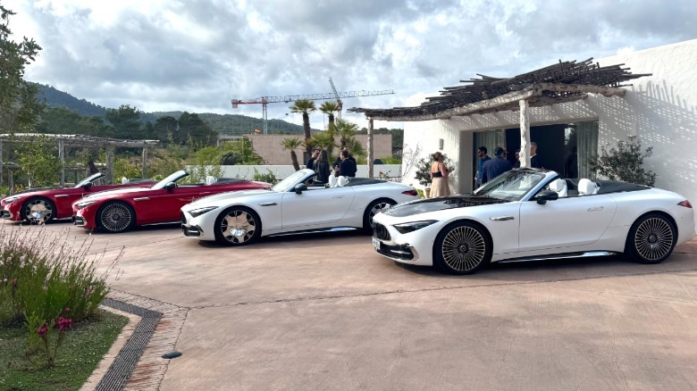 four Maybach SLs parked next to each other with their tops down