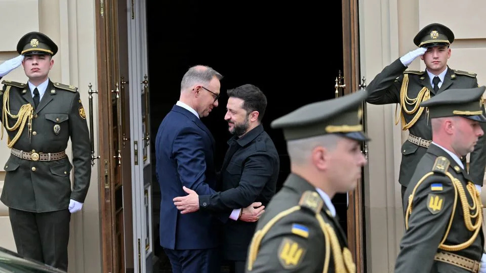 Ukrainian President Volodymyr Zelensky and Poland's President Andrzej Duda greet each other as they arrive for their meeting outside Mariinskyi Palace in Kyiv, Ukraine on June 28, 2025. - Sergei Supinksy/AFP/Getty Images/File