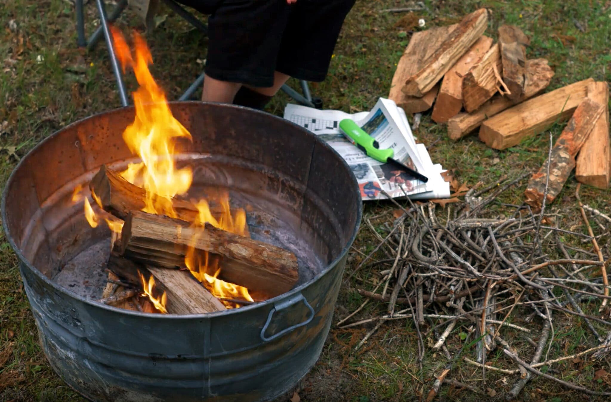 A side image of a campfire built into a metal tub. 