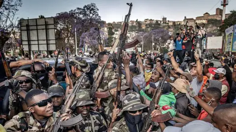 AFP via Getty Images  Members of a section of the Malagasy army ride on a pickup truck to secure the area around Lake Anosy as protesters celebrate their arrival following clashes between demonstrators and security forces during protests calling for the resignation of President Andry Rajoelina in Antananarivo, on October 11, 2025