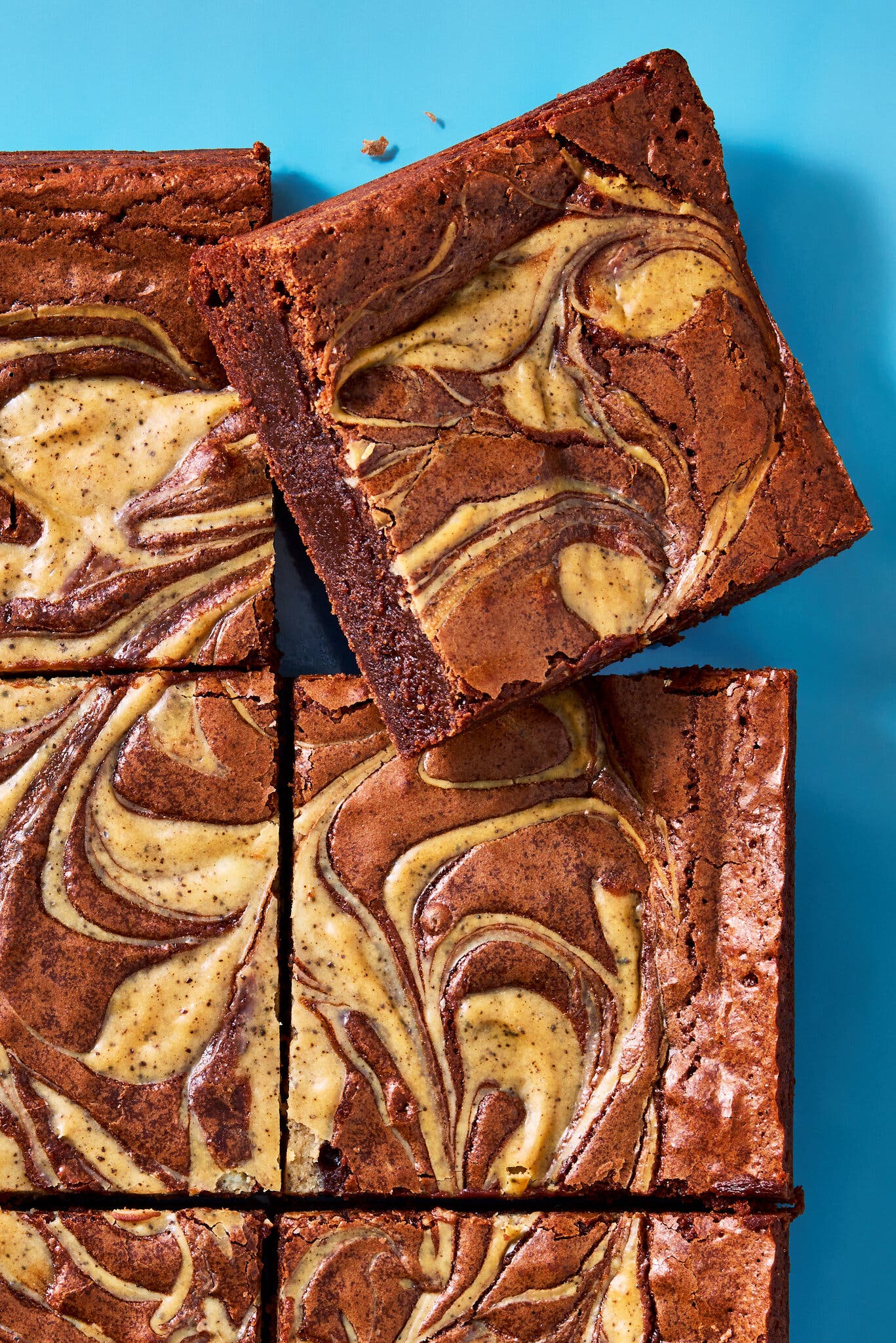An overhead image of brownies with a creamy swirl atop.