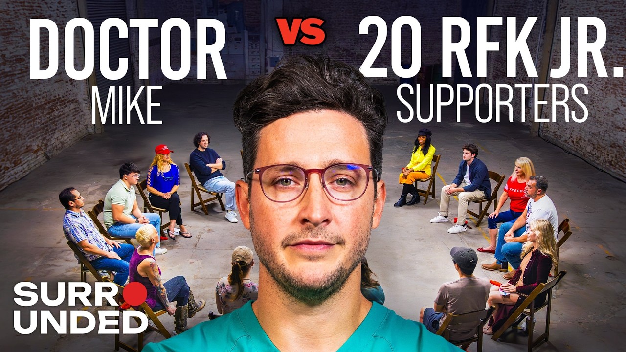 A man in medical scrubs stands in the center foreground with a serious expression. Behind him, two groups of people sit in a large circle in a warehouse-like space. Text reads: "Doctor Mike vs 20 RFK Jr. Supporters.